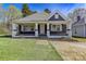 Charming single-story home featuring a covered front porch and well-maintained lawn in a quiet neighborhood at 209 N Yadkin Ave, Spencer, NC 28159