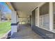 Spacious covered front porch with painted brick columns, offering an inviting outdoor living space at 209 N Yadkin Ave, Spencer, NC 28159