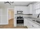 Bright kitchen features granite countertops, stainless steel appliances, and ample cabinet space at 209 N Yadkin Ave, Spencer, NC 28159