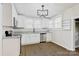 Updated kitchen with white cabinets, stainless steel appliances and granite countertops at 209 N Yadkin Ave, Spencer, NC 28159