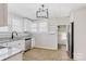 Updated kitchen with white cabinets, stainless steel appliances and granite countertops at 209 N Yadkin Ave, Spencer, NC 28159