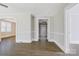 Open-concept living room showcasing archway and wood flooring at 209 N Yadkin Ave, Spencer, NC 28159