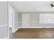 Bright living room featuring hardwood floors, fresh paint, and ample natural light from large windows at 209 N Yadkin Ave, Spencer, NC 28159