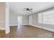Inviting living room with hardwood floors, large windows, and a ceiling fan for added comfort at 209 N Yadkin Ave, Spencer, NC 28159