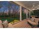 Covered back porch featuring outdoor seating and views of the manicured backyard at 209 Sardis Ln, Charlotte, NC 28270