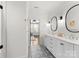 Bright bathroom features a dual sink vanity with white cabinets and patterned floor tiles at 209 Sardis Ln, Charlotte, NC 28270