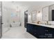 This luxurious bathroom has a soaking tub, double vanity, and modern fixtures for a spa-like experience at 209 Sardis Ln, Charlotte, NC 28270