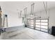 Spacious, well-lit garage with an epoxy floor, storage solutions, and glass panel garage doors at 209 Sardis Ln, Charlotte, NC 28270