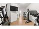 Hallway featuring exercise machines and a mounted television at 209 Sardis Ln, Charlotte, NC 28270