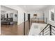 Upstairs hallway features wood floors, a modern railing, and access to the living spaces at 209 Sardis Ln, Charlotte, NC 28270