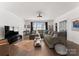 Spacious living room with hardwood floors, dark window accents, and a comfortable sectional sofa at 209 Sardis Ln, Charlotte, NC 28270