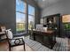 This home office has large windows, a stately desk, and is perfect for work and study with ample natural light at 209 Sardis Ln, Charlotte, NC 28270