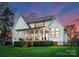 A spacious covered back porch with stairs to a lush, level yard creates an inviting outdoor retreat at 209 Sardis Ln, Charlotte, NC 28270