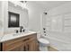 This bathroom features a wood vanity and a tub and shower combo with black hardware at 2120 Green Oak Dr, Shelby, NC 28152