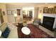 Inviting living room featuring a fireplace, comfortable seating, and abundant natural light at 21205 Cold Spring Ln, Cornelius, NC 28031