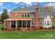 Expansive brick home featuring a covered porch and well-maintained landscaping at 21721 Shoveller Ct, Cornelius, NC 28031