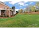 Spacious backyard featuring lush green lawn and mature trees at 21721 Shoveller Ct, Cornelius, NC 28031