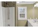 Bathroom featuring a shower and vanity with a window providing natural light at 21721 Shoveller Ct, Cornelius, NC 28031