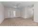 Spacious bonus room offering plush carpet, neutral walls, a ceiling fan, and white doors at 21721 Shoveller Ct, Cornelius, NC 28031