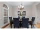 Formal dining room featuring stylish chandelier, six chairs, and a beautiful window with a custom top at 21721 Shoveller Ct, Cornelius, NC 28031