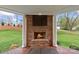 Outdoor fireplace with a beautiful brick design, perfect for cozy evenings outside at 21721 Shoveller Ct, Cornelius, NC 28031