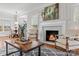 Cozy living room showcasing a fireplace, hardwood floors, and elegant decor at 21721 Shoveller Ct, Cornelius, NC 28031
