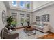 Sunlit living room featuring a neutral color palette, comfortable seating, hardwood floors, and elegant decor at 21721 Shoveller Ct, Cornelius, NC 28031