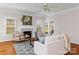 Bright and airy living room featuring hardwood floors, a fireplace, and access to the outdoors at 21721 Shoveller Ct, Cornelius, NC 28031