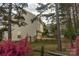 Spacious backyard with a wooden fence, deck, and beautiful landscaping with some pink flowers at 2919 Bridgeville Ln, Charlotte, NC 28262