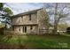 Large backyard with a wooden fence and deck overlooking green space at 2919 Bridgeville Ln, Charlotte, NC 28262