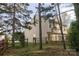 Spacious backyard with a wooden fence and deck overlooking a green space at 2919 Bridgeville Ln, Charlotte, NC 28262