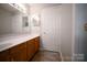 Bathroom vanity with double sinks, light fixtures, and white countertops at 2919 Bridgeville Ln, Charlotte, NC 28262