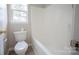 Bathroom featuring a toilet and shower/tub with a window for natural light at 2919 Bridgeville Ln, Charlotte, NC 28262