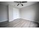 Bedroom with neutral walls, wood-look floors, ceiling fan, and a closet at 2919 Bridgeville Ln, Charlotte, NC 28262