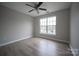 Bedroom with neutral walls, wood-look floors, ceiling fan, and natural light from a window at 2919 Bridgeville Ln, Charlotte, NC 28262