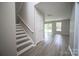 Bright living room features new wood flooring and access to the backyard through sliding glass doors at 2919 Bridgeville Ln, Charlotte, NC 28262