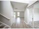 A well-lit view from the entryway showing the french doors, living room, and staircase at 2919 Bridgeville Ln, Charlotte, NC 28262