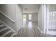 A light-filled living room with new wood flooring and access to other rooms via a doorway at 2919 Bridgeville Ln, Charlotte, NC 28262