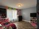 Bright bedroom featuring laminate wood floor and large window with curtain at 300 S Oakland Ave, Statesville, NC 28677