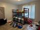 Bedroom with wood bunk bed and window with curtain at 300 S Oakland Ave, Statesville, NC 28677
