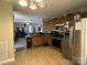 Cozy kitchen featuring wooden cabinetry, stainless steel appliances, and tile flooring at 300 S Oakland Ave, Statesville, NC 28677