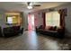 Inviting living room featuring wood-look floors, comfortable seating, and an open doorway at 300 S Oakland Ave, Statesville, NC 28677
