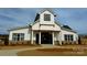 The community clubhouse features a modern farmhouse style with stone and white siding accents at 3008 Bramble Hedge Dr # 3272, Indian Trail, NC 28079