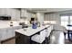 Modern kitchen with stainless steel appliances, a large island with seating, and sleek cabinetry at 3008 Bramble Hedge Dr # 3272, Indian Trail, NC 28079