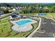 Aerial view of a community pool with a clubhouse, tennis courts, parking lot, and playground at 3008 Bramble Hedge Dr # 3272, Indian Trail, NC 28079