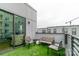 Outdoor balcony with seating, artificial turf, and views of the surrounding area at 3105 Beans Blvd, Charlotte, NC 28203