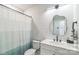 Bright bathroom featuring a modern vanity, decorative mirror, and contemporary shower curtain at 3105 Beans Blvd, Charlotte, NC 28203