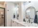 Elegant bathroom featuring dual sinks, modern black fixtures, sleek mirrors, and a tiled shower with glass door at 3105 Beans Blvd, Charlotte, NC 28203