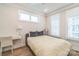 Cozy bedroom with natural light, a desk, and soft decor to promote a relaxing and comfortable ambiance at 3105 Beans Blvd, Charlotte, NC 28203