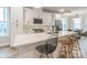 Modern kitchen featuring white cabinets, quartz countertops, and a sleek island with bar seating at 3105 Beans Blvd, Charlotte, NC 28203